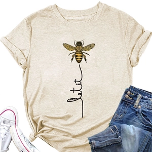 Flat lay of beige cotton T-shirt featuring a bee graphic and 'Let It Be' artistic script
