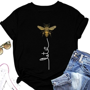 Flat lay of women's black T-shirt with bee print and casual summer accessories