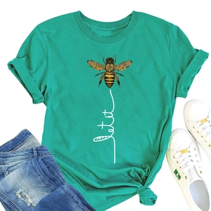Flat lay of mint green Let It Be bee print tee paired with denim and white sneakers