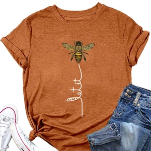 Detail of Let it be bee graphic on orange short sleeve t-shirt with jeans and sneakers