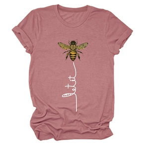 Close-up of bee print and Let It Be calligraphy on soft pink cotton blend t-shirt