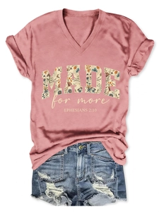 Detail of mauve V-neck T-shirt with 'MADE for more' floral text and denim shorts