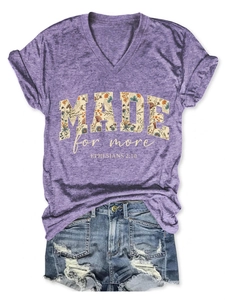 Detail of purple V-neck T-shirt with floral Made for More print and Bible verse text