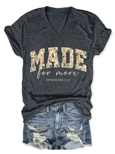 Flat lay of gray V-neck T-shirt with MADE for more floral print and denim shorts