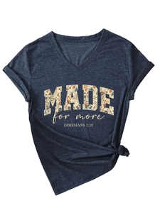 Detail of V-neck T-shirt with rolled sleeves, front knot design, and floral lettering print
