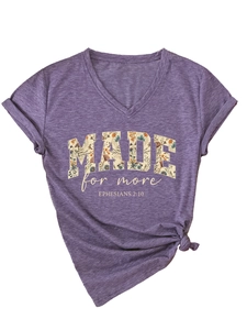 Detail of purple V-neck T-shirt featuring flower letters and side knot styling