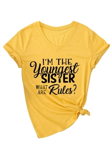 Detail of V-neck yellow T-shirt with I'M THE Youngest SISTER print and front knot hem