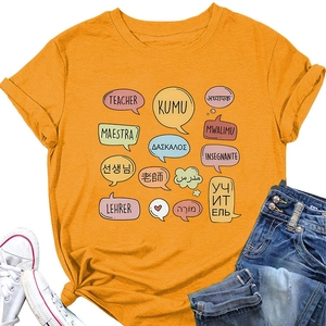 Flat lay of ginger yellow teacher T-shirt with multi-language greetings and denim jeans