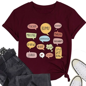 Flat lay of wine red teacher t-shirt with multi-language text print and canvas shoes