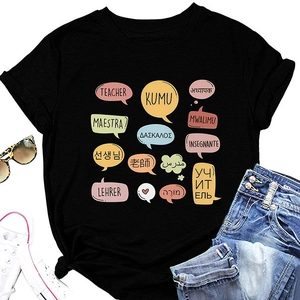 Flat lay of teacher t-shirt with multilingual colorful bubbles and stylish accessories