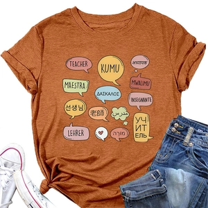 Detailed flat lay of terracotta teacher t-shirt with multilingual teacher print graphics