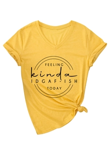 Detail of yellow V-neck T-shirt with 'IDGAF-ISH' print and side knot hem detail