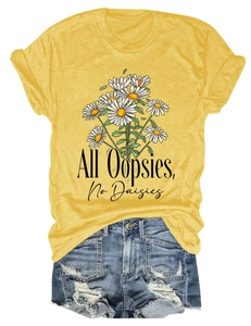Detail of yellow T-shirt with daisy print and slogan paired with ripped denim shorts