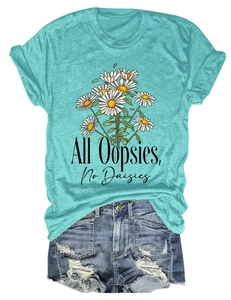 Flat lay of teal T-shirt with All Oopsies No Daisies floral print and denim shorts