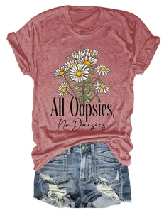 Flat lay of pink cotton T-shirt with daisy print and distressed denim shorts on white background