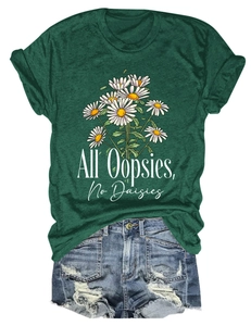 Detailed view of dark green t-shirt with daisy print and distressed denim shorts
