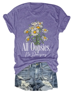 Flat lay of purple short sleeve t-shirt with daisy graphic and distressed denim shorts