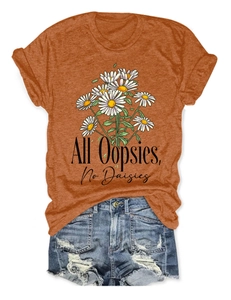 Flat lay of rust orange cotton T-shirt with daisy print and distressed denim shorts