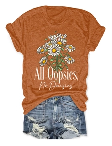 Detailed flat lay of women's orange daisy t-shirt and distressed denim shorts set