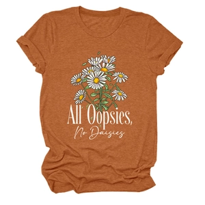 Detail of the orange cotton T-shirt featuring a white daisy graphic and artistic text