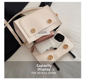 Interior capacity of the cream crossbody bag showing phone, wallet, and power bank