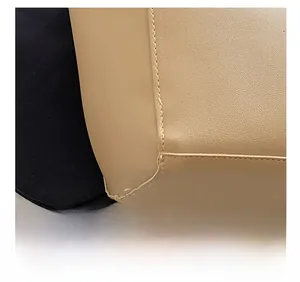 Macro shot of precise stitching on light beige leather corner of a large tote bag