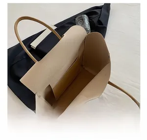 Detailed top view of the beige tote bag interior featuring spacious storage and a side pocket