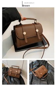 Dettaglio borsa a tracolla marrone vintage con fibbie dorate e tracolla regolabile