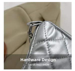 Detailed close-up of silver quilted shoulder bag featuring metal hardware and fine stitching