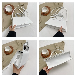 Detail view of white PU leather crossbody bag with silver geometric metal handle