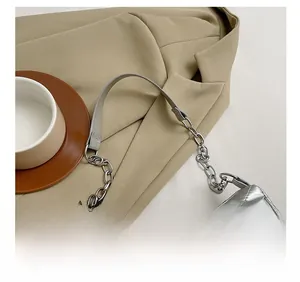 Close-up of comfortable shoulder strap on silver lattice quilted bag with metal chain