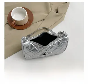 Detailed view of silver quilted handbag featuring star emblem and secure zipper closure