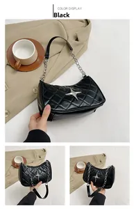 Close-up of quilted black shoulder bag with silver star detail and metal chain strap