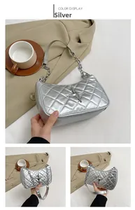 Detail of silver quilted shoulder bag with star-shaped buckle and metal chain strap