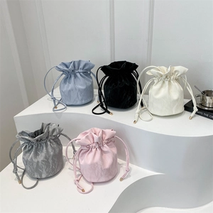 Stylish pleated drawstring bucket bags in five colors with metallic gold accents
