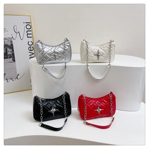 Detail view of four colors of quilted crossbody bags with silver star charms and chain straps