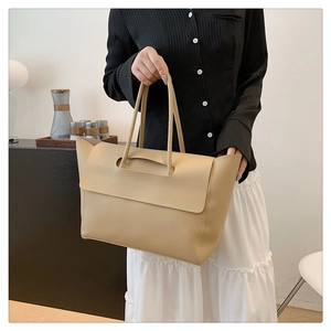 Minimalist beige oversized faux leather tote bag for women, perfect for daily commuting