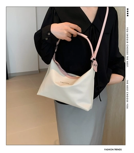 Detail of soft PU leather shoulder bag with pink straps and FASHION lettering