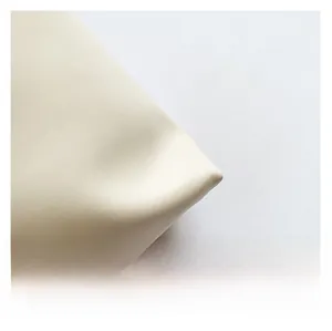 Macro shot of high-quality cream white faux leather texture for stylish tote bag