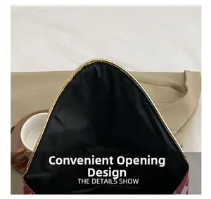 Detail showing the convenient wide-open design and gold metal trim of the envelope clutch