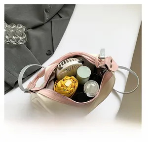 Interior view of the cream tote bag showing capacity for an umbrella, fan, and skincare products