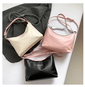 Detailed overhead view of fashion tote bags in cream, pink, and black colors