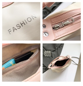 Detailed close-up of fashion tote bag showing metal zippers, stitching, and interior pockets