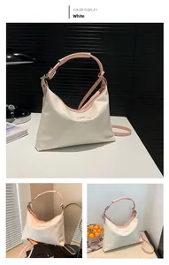 Detail of white PU leather tote with pink handles and adjustable shoulder strap