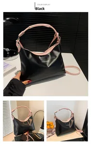 Detail of black Hobo tote bag with pink contrast handles and fashion lettering