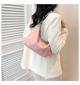 On-body view of a pink matte tote bag with Fashion text and grey woven shoulder strap