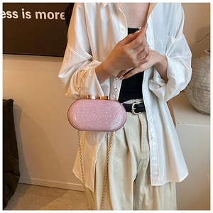 Pink sequin evening clutch bag with gold bow clasp and metal chain link handle