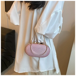 Detailed view of pink glitter evening bag with gold bow clasp and metallic handle