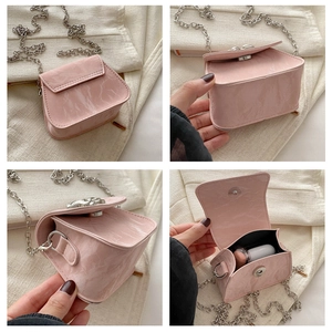 Detail view of pink textured mini chain bag with marble pattern and silver hardware