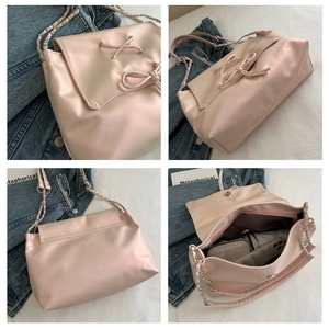 Pink soft leather tote detail showing large capacity, leather bow, and metal chain strap